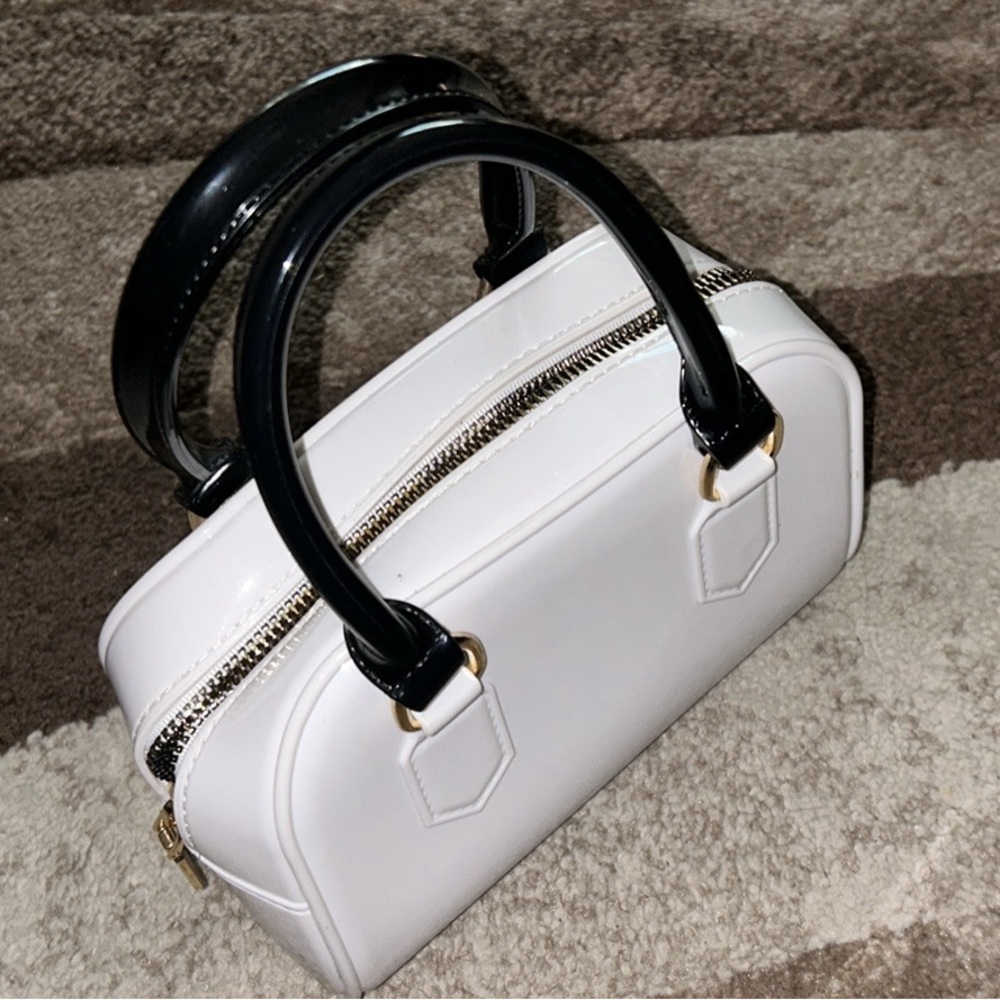 Black and white purse with roomy inside, option of off the shoulder gold chain.